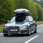 Audi A6 Avant mit Dachbox auf der Autobahn