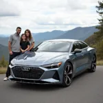 Moderne Audi E-Tron Familie lächelt glücklich vor malerischer Landschaft