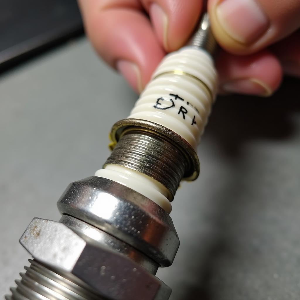 Inspecting the spark plug of an Aprilia SR 50