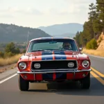 Ford Mustang Oldtimer 1967 fährt auf einer malerischen Straße.