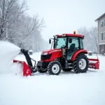 Kleintraktor mit Schneeschild und Schneefräse im Winterdienst